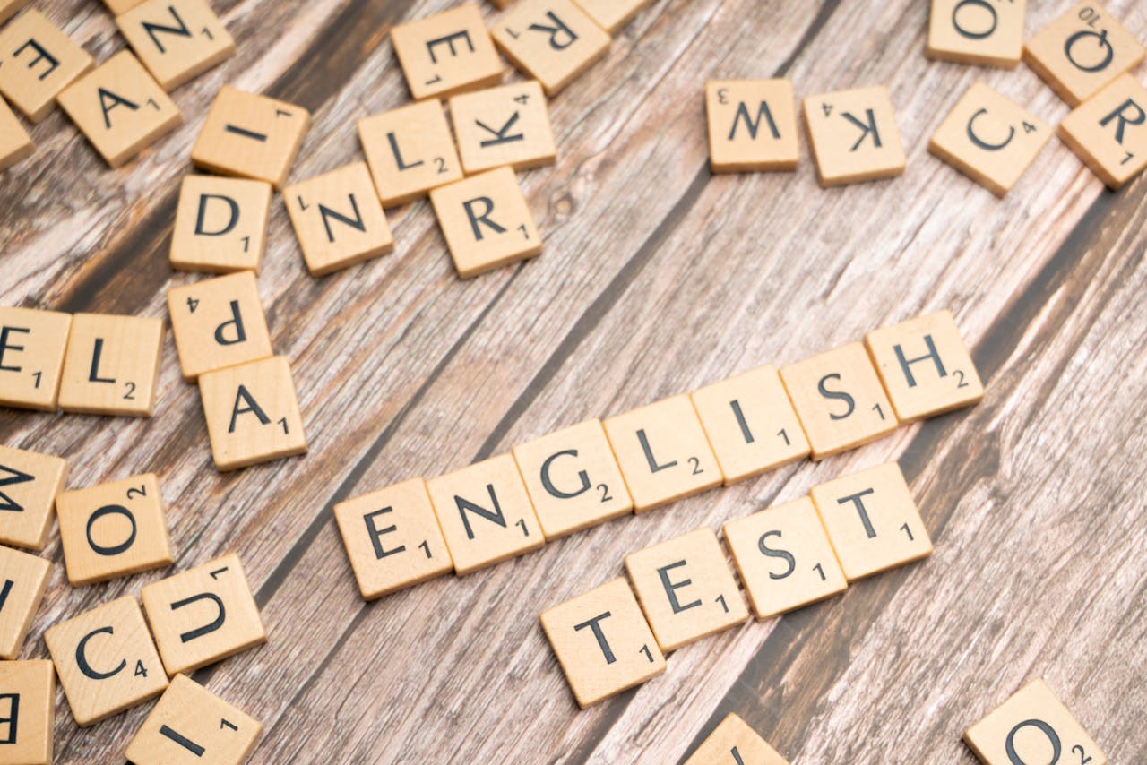 Services Wooden Scrabble tiles spelling out 'English Test' on a wooden background, ideal for language exam themes.