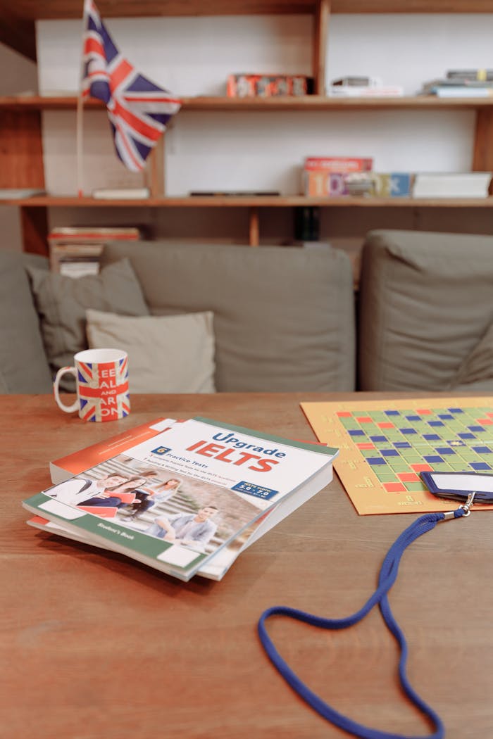 Services IELTS prep materials on a coffee table with a British flag mug and decor. Ideal for education themes.