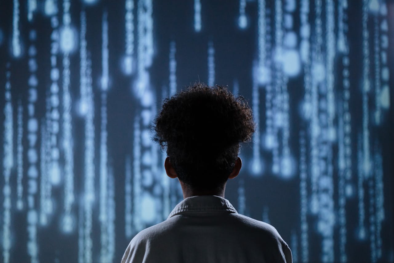 Home A young boy viewing a digital screen with data streams, symbolizing technology interaction.